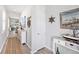 Bright hallway featuring coastal decor leading into an open-concept living space at 10418 Spring Tide Way, Parrish, FL 34219