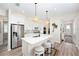 Stylish kitchen featuring a central island with bar seating and modern pendant lighting at 10418 Spring Tide Way, Parrish, FL 34219