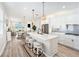 Modern kitchen featuring white cabinets, quartz countertops, and stainless steel appliances at 10418 Spring Tide Way, Parrish, FL 34219