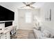 Home office with a couch, artwork, modern desk, and plenty of sunlight at 10418 Spring Tide Way, Parrish, FL 34219