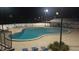 Sparkling community swimming pool at night with ample seating and a cozy ambiance at 105 Lake Tarpon Dr # 26, Palm Harbor, FL 34684