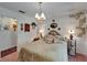 Well decorated bedroom with a bed, chandelier, side tables and great natural light at 11120 Lu Wista Ln, Brooksville, FL 34601