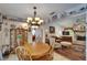 Dining area features french doors, chandelier, decor plate shelving, and wood table at 11120 Lu Wista Ln, Brooksville, FL 34601
