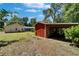 Outbuilding with attached carport offering convenient storage space and easy access at 11120 Lu Wista Ln, Brooksville, FL 34601