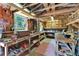 Outbuilding interior with ample storage, featuring wooden workbenches and shelving at 11120 Lu Wista Ln, Brooksville, FL 34601