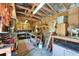 Well-organized interior of outbuilding, with exposed wooden beams and ample storage for tools and equipment at 11120 Lu Wista Ln, Brooksville, FL 34601