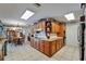 Bright kitchen featuring custom cabinets and a view to an adjacent dining area, ideal for entertaining at 11120 Lu Wista Ln, Brooksville, FL 34601