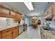 Bright kitchen boasts granite countertops, wood cabinets, stainless dishwasher, and decorative dishware at 11120 Lu Wista Ln, Brooksville, FL 34601