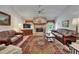 Spacious living room offers a stone fireplace, leather sofas, and an oriental rug at 11120 Lu Wista Ln, Brooksville, FL 34601