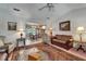 Living room view features decor art and lamps, a view to dining, and leather sofas at 11120 Lu Wista Ln, Brooksville, FL 34601