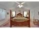 Main bedroom offers a four-poster bed, matching lamps, and comfortable design at 11120 Lu Wista Ln, Brooksville, FL 34601