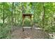 Outdoor wooden structure with bench along a trail in wooded setting at 11120 Lu Wista Ln, Brooksville, FL 34601