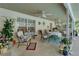 Cozy covered patio featuring ceiling fans, comfortable seating, and tasteful decor perfect for relaxing or entertaining at 11120 Lu Wista Ln, Brooksville, FL 34601