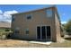 A view of the back of this home, which has a large sliding glass door that opens to the backyard space at 1118 Lauren Manor Loop, Ruskin, FL 33570