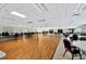 An expansive ballroom with wood flooring, tables, chairs, and abundant natural light offers the perfect event space at 11723 Boynton Ln # 1, New Port Richey, FL 34654