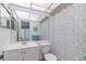 Clean bathroom with a modern sink, toilet, and shower/tub combo at 11723 Boynton Ln # 1, New Port Richey, FL 34654