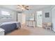 Bright bedroom features a ceiling fan, neutral walls, and direct bathroom access at 11723 Boynton Ln # 1, New Port Richey, FL 34654