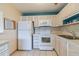 Kitchen with white appliances and neutral countertops at 11723 Boynton Ln # 1, New Port Richey, FL 34654