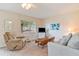 Cozy living room featuring comfortable seating and a large window at 11723 Boynton Ln # 1, New Port Richey, FL 34654