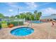 Relaxing community pool area showcasing a hot tub, poolside seating, and lush landscaping at 11723 Boynton Ln # 1, New Port Richey, FL 34654