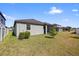 Spacious backyard with a well-maintained lawn and a view of the neighboring houses at 11831 Thicket Wood Dr, Riverview, FL 33579