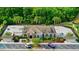 Stunning clubhouse featuring a luxurious pool, ample parking, lush landscaping and a beautiful architectural design at 11831 Thicket Wood Dr, Riverview, FL 33579