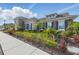 Charming exterior featuring stone accents, well-maintained landscaping, and colorful plants at 11831 Thicket Wood Dr, Riverview, FL 33579