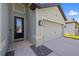 Inviting home featuring a traditional front door, a two-car garage, and manicured landscaping at 11831 Thicket Wood Dr, Riverview, FL 33579