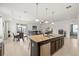 Open-concept kitchen and dining area featuring granite countertops and modern appliances at 11831 Thicket Wood Dr, Riverview, FL 33579