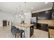 Spacious kitchen island with bar seating, granite countertops, and stainless steel appliances at 11831 Thicket Wood Dr, Riverview, FL 33579