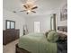 Comfortable main bedroom features ceiling fan and a view of the ensuite bath at 11831 Thicket Wood Dr, Riverview, FL 33579