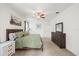 Relaxing main bedroom with soft carpet, ceiling fan, and ample closet space at 11831 Thicket Wood Dr, Riverview, FL 33579