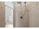 Shower with tiled walls and glass door featuring a traditional shower head as well as a rainfall shower head at 11831 Thicket Wood Dr, Riverview, FL 33579