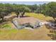 Aerial view of a well-maintained home on sprawling acreage with lush landscaping, mature trees, and a charming front porch at 1202 Williams Rd, Plant City, FL 33565