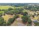 Vast landscape featuring farmland, mature trees, multiple houses, and a peaceful pond, showcasing the area's natural beauty at 1202 Williams Rd, Plant City, FL 33565