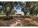 Expansive backyard featuring a picnic table and fire pit, perfect for outdoor entertaining at 1202 Williams Rd, Plant City, FL 33565