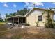 View of the backyard and screened in porch of the house with sunny skies at 1202 Williams Rd, Plant City, FL 33565