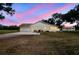 Exterior view of home, showing the attached garage, extra garage and spacious backyard at 1202 Williams Rd, Plant City, FL 33565
