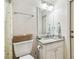 Cozy bathroom featuring a single sink vanity, toilet, and neutral decor at 1202 Williams Rd, Plant City, FL 33565
