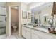 Bathroom with double sink vanity with granite countertop, toilet, and glass-enclosed shower at 1202 Williams Rd, Plant City, FL 33565
