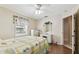 Bright bedroom featuring a window with valance, ceiling fan, and classic furnishings at 1202 Williams Rd, Plant City, FL 33565