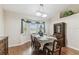 Bright dining room features hardwood floors, a bay window and a decorative buffet and china cabinet at 1202 Williams Rd, Plant City, FL 33565