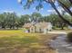 Charming single-story home featuring a well-maintained lawn, mature trees and a long driveway leading to a private residence at 1202 Williams Rd, Plant City, FL 33565