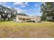 Single-story home with a well-maintained lawn and mature trees surrounding the property at 1202 Williams Rd, Plant City, FL 33565
