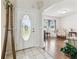 Bright foyer with a decorative front door and tile flooring leads to the living room at 1202 Williams Rd, Plant City, FL 33565