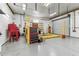 A spacious garage is equipped with a vehicle lift and various tools, offering space for automotive projects at 1202 Williams Rd, Plant City, FL 33565