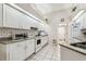 Bright kitchen with white cabinets, subway tile backsplash, and tile flooring at 1202 Williams Rd, Plant City, FL 33565