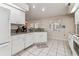 Spacious kitchen showcasing white cabinets, granite counters, and tile floors at 1202 Williams Rd, Plant City, FL 33565