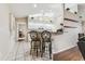 Open kitchen with white cabinets, granite counters, and breakfast bar seating at 1202 Williams Rd, Plant City, FL 33565