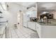 Kitchen with stainless sink, granite counters, and white cabinetry at 1202 Williams Rd, Plant City, FL 33565